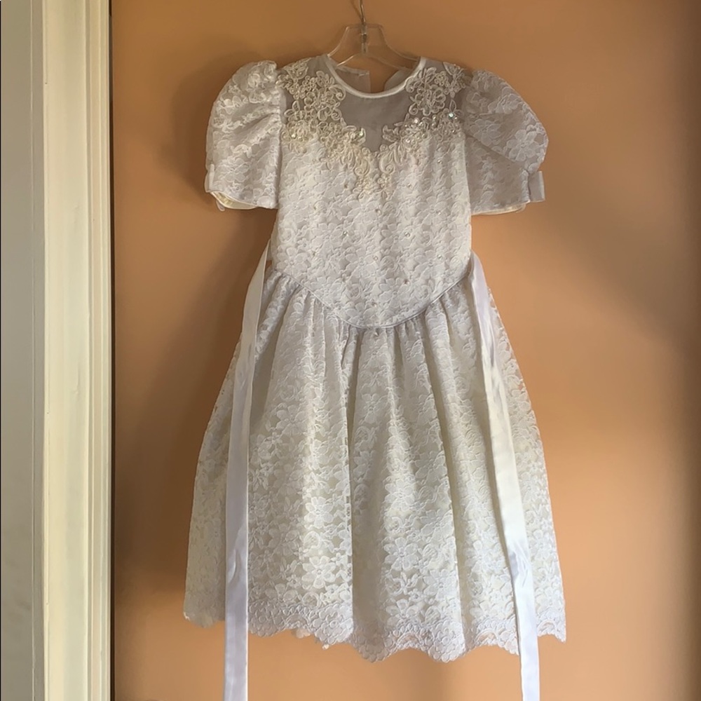 Little girl’s white beaded and lace ball gown
